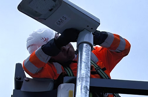 employee fixing street lighting