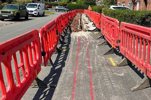 safety barriers blocking excavated section of residential street